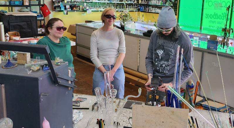 Group of people watching a glass blowing demonstration