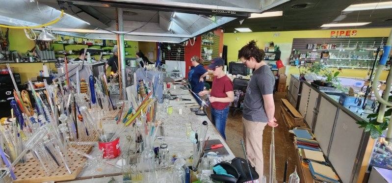 Wide shot of the Glass Gods studio with multiple students at work